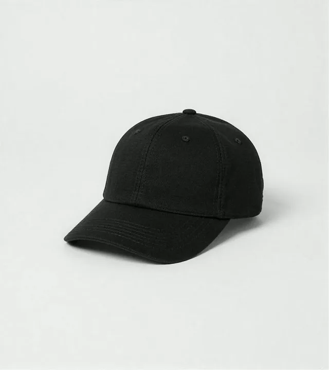 Black six-panel cap photographed against a light gray studio background