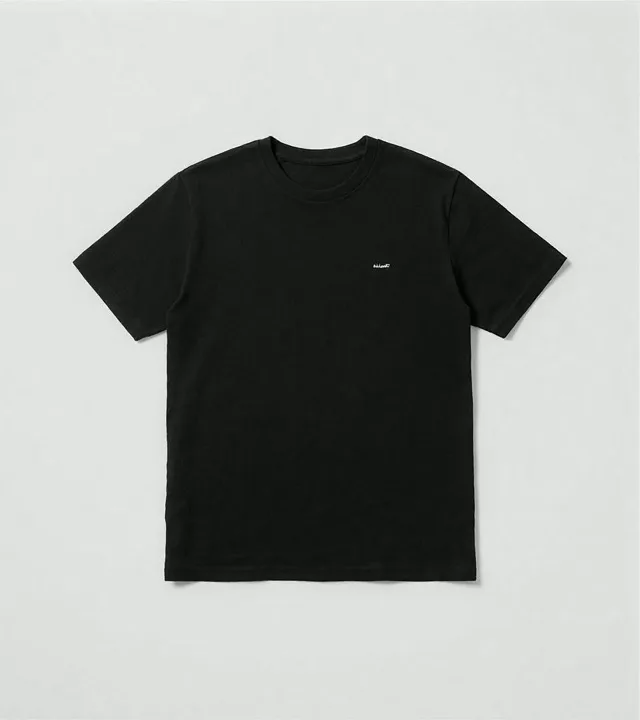 Black standard tee laid flat against a light gray studio background